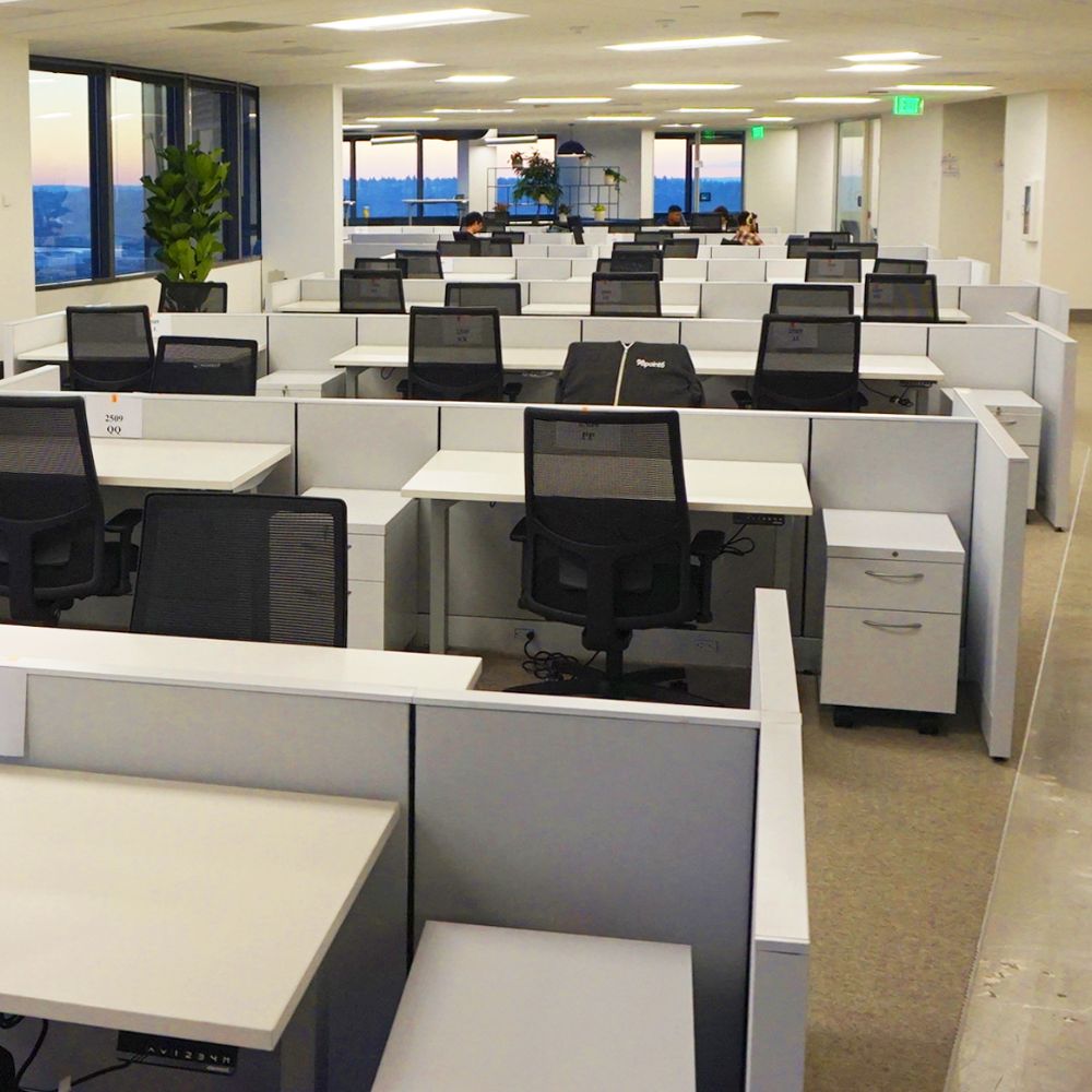 Ninety-eight workstations arranged in rows on an office floor