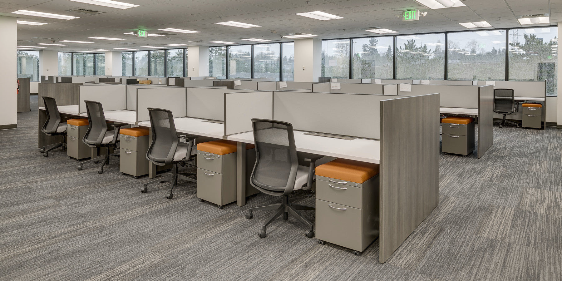 Workstations with storage pedestals installed along office windows