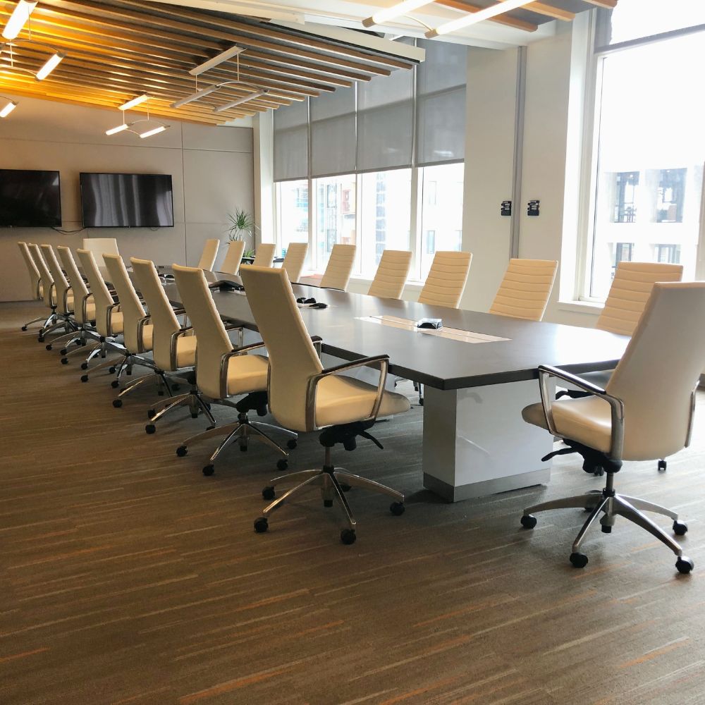 A long conference table with leather chairs in a meeting room