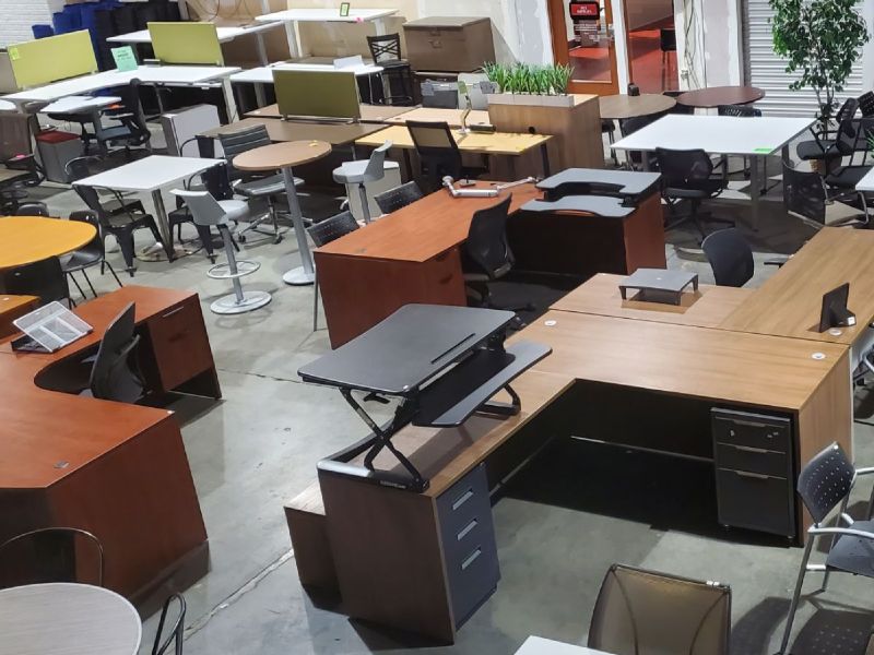 Pre-owned desks and chairs on the floor of the Ducky's showroom in Seattle